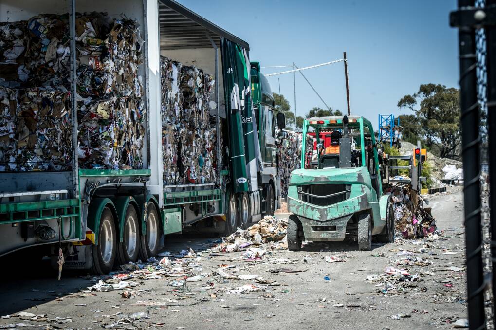 A truck at the Hume recycling facility is loaded with bales of compressed recyclables. Staff at the centre said the bales were headed "to market". Photo: Karleen Minney