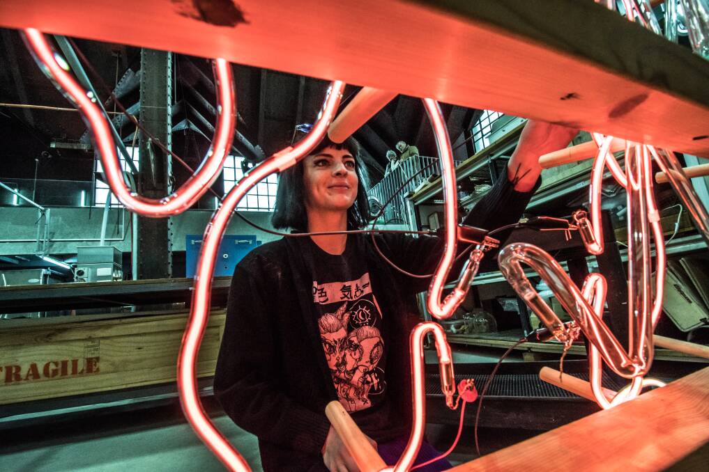 Emma-Kate Hart, who is the Winter Glass artist-in-residence, working on her piece, a neon sculpture entitled Electric Bell Jar.  Photo: Karleen Minney 