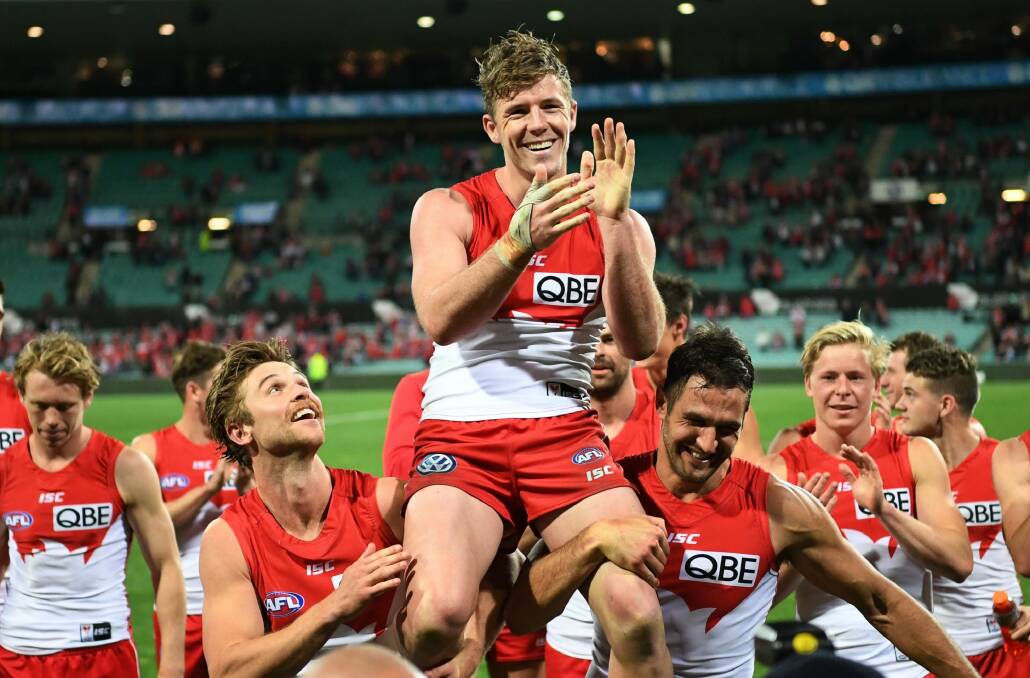 Luke Parker is chaired off by teammates after playing his 150th game, against the Bombers in this year's finals. Photo: AAP