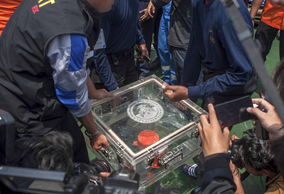 The box containing flight data is carried ashore on Thursday. 
 Photo: AP