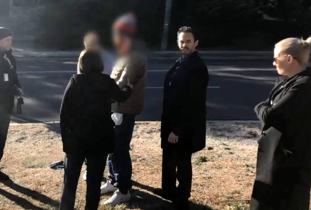 Police arrest a man (with his face blurred) in Jindabyne on Tuesday over the alleged sexual assault of a woman and the assault of a man. Photo: NSW Police 