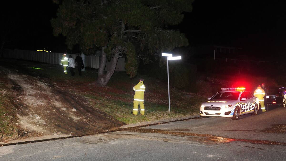 Emergency services attend a car fire off Hawkesbury Crescent in Farrer Thursday night. Police believe the car was used in the robbery. Photo: Melissa Adams