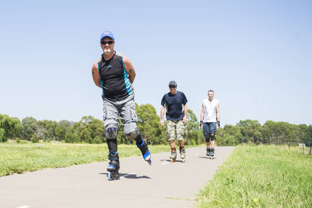 Steve Lowe, Geoff Galwey, and Russell Koehne rollerblade at the Jerrabomberra Wetlands on Saturday. Photo: Dion Georgopoulos