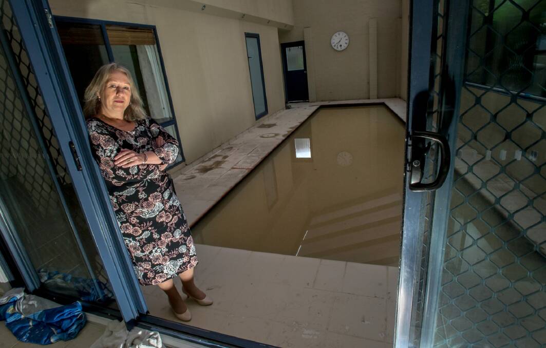 Ruth Fenwick's home in Kambah was flooded during the deluge on Saturday due to run-off from the neighbouring property. The pool and surrounding area was filled with muddy water. Photo: Karleen Minney
