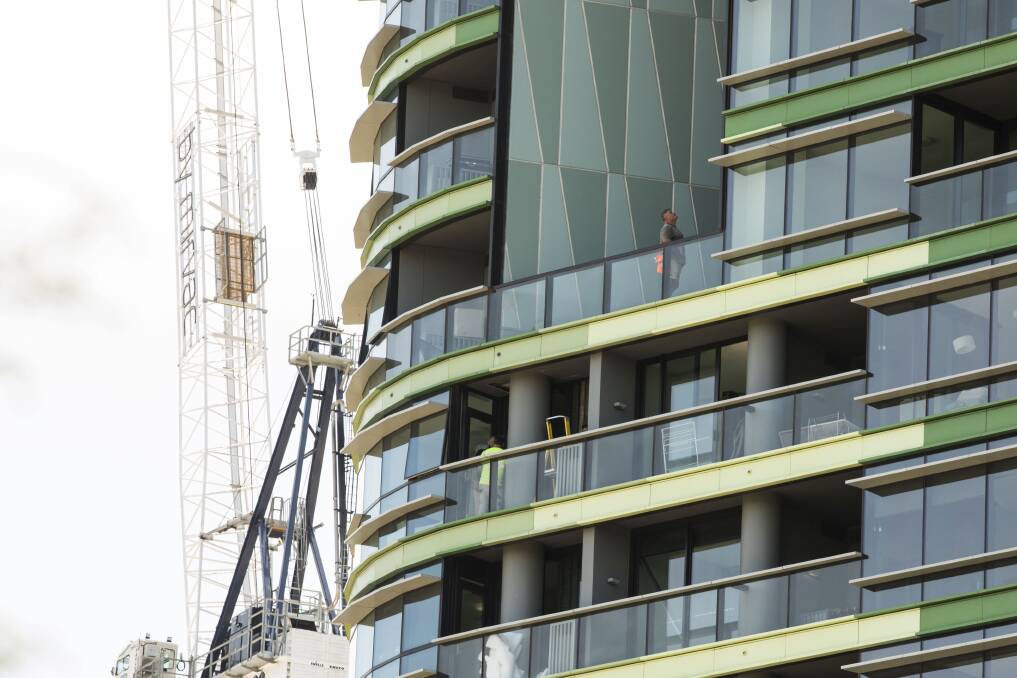Tradesmen working on Opal Tower in Olympic Park. Photo: Dominic Lorrimer