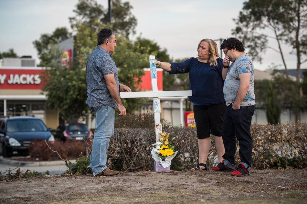 Ron and Leesa Topic, along with oldest son Kris, gather at the site where their daughter and sister Courtney died.  Photo: Wolter Peeters