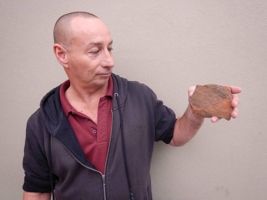 Steve Hill with the Uluru rock he believes has brought him ''nothing but bad luck''. Photo: Tim the Yowie Man