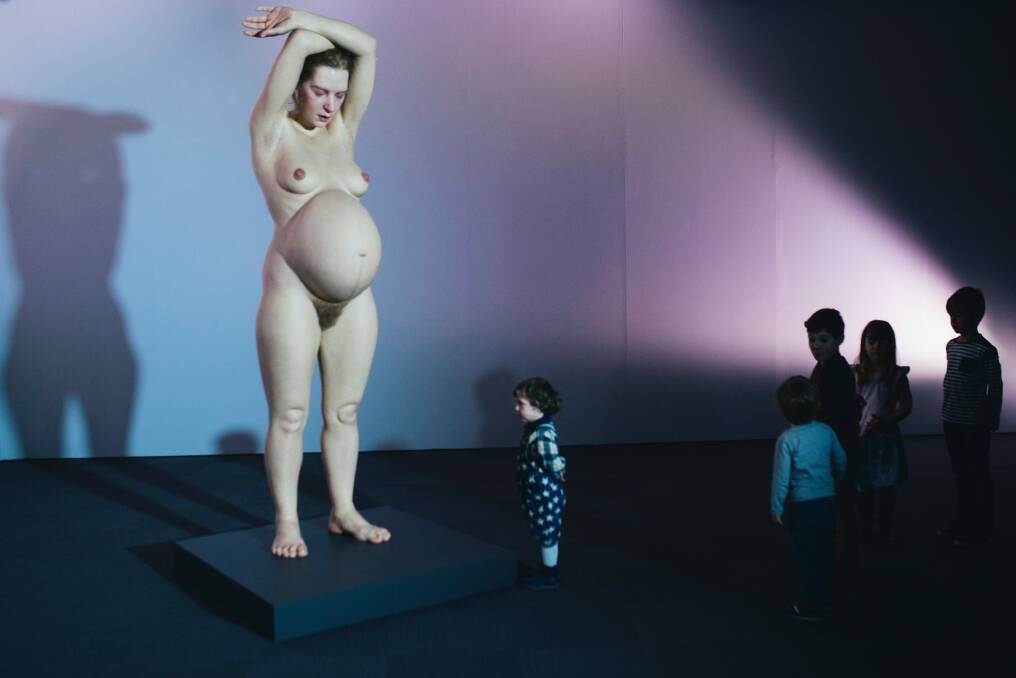 Yazid El-Aasar, 2, of Queanbeyan gets up close with Ron Mueck's Pregnant Woman. Photo: Rohan Thomson