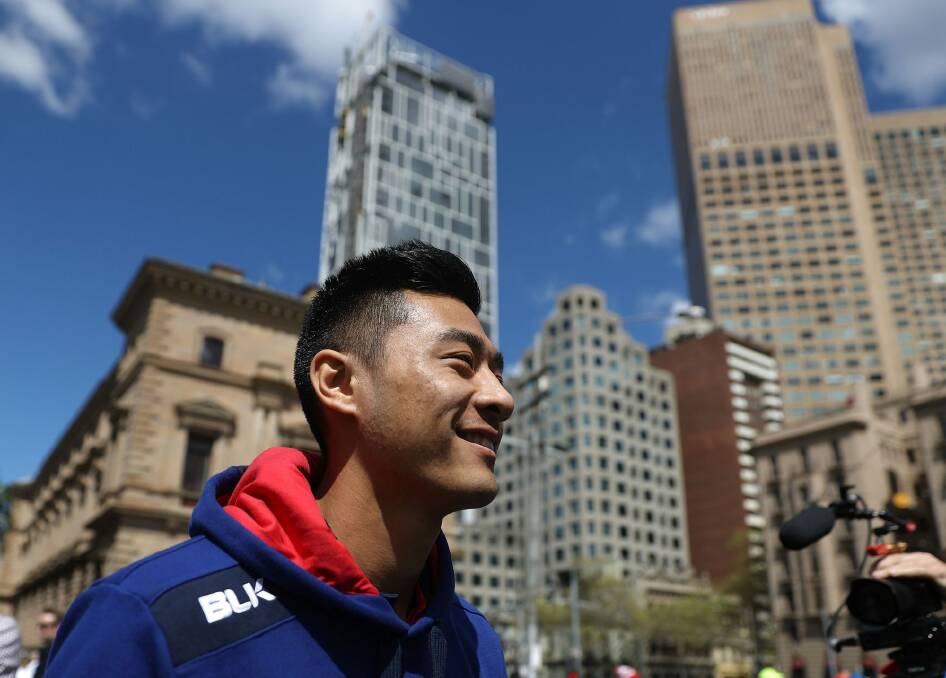 Still smiling: Lin Jong of the Bulldogs during the grand final parade. Photo: Getty Images