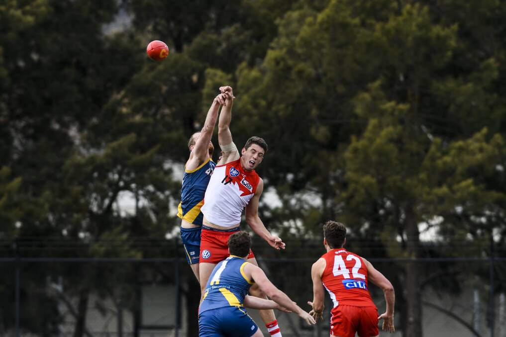 Canberra's Cameron Milne and Sydney's Darcy Cameron contest the ball. Photo: Dion Georgopoulos
