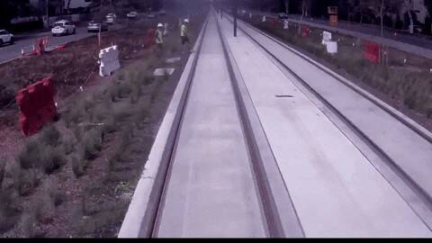 A construction worker narrowly avoids being hit by light rail. Photo: Transport Canberra