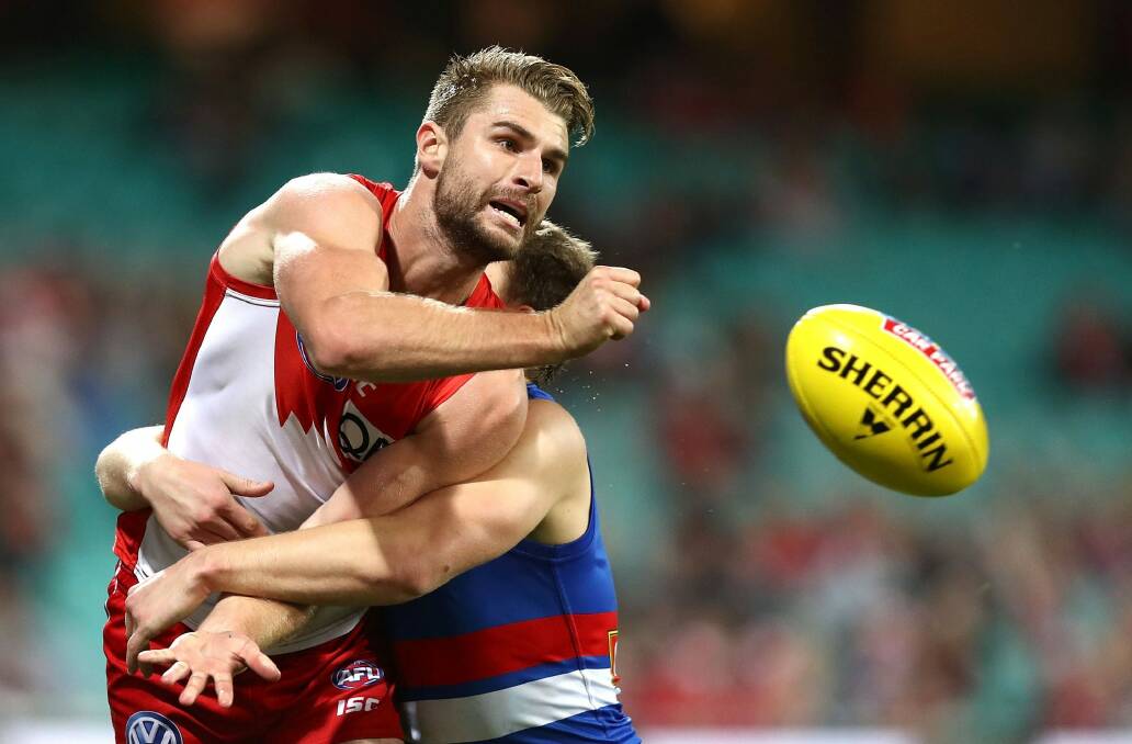 On the ball: Harrison Marsh passes as he's tackled. Photo: Getty Images