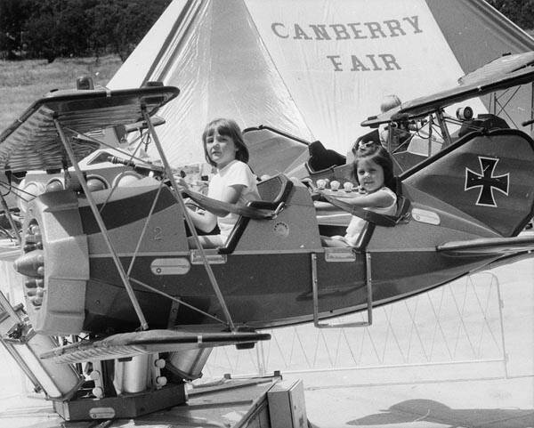 Heather Carter from Randwick, Sydney, left, and Rebecca Johnston of Reid on the Red Baron aircraft ride at Canberry Fair. Photo: ACT Heritage Library/The Canberra Times Collection