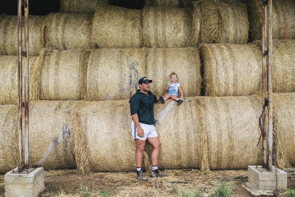 Brumbies hooker Josh Mann-Rea with daughter Avery at their home in Jugiong. He drives 90 minutes to Canberra for Super Rugby training every day. Photo: Rohan Thomson