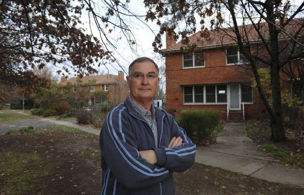 John Keeley in front of two government-owned duplexes in Boolimba Crescent, Narrabundah, which are to be demolished to make way for nine public housing units. Photo: Graham Tidy
