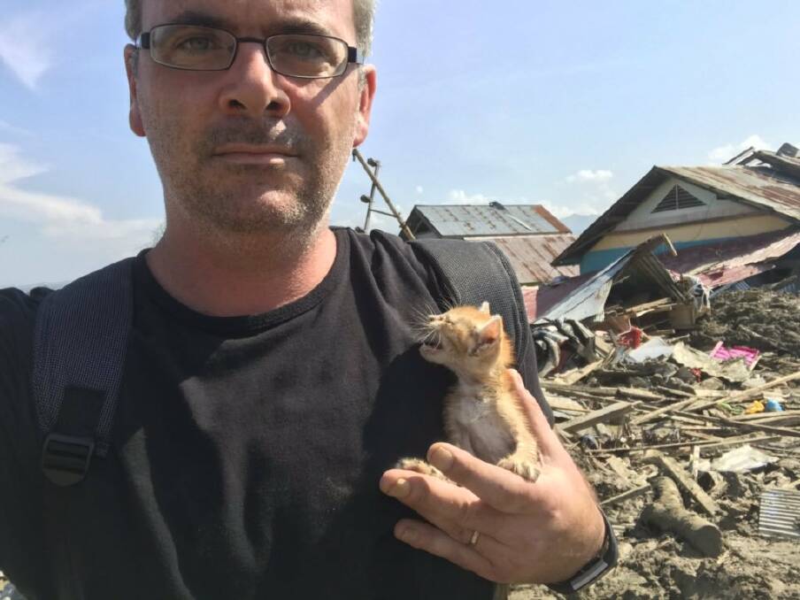 Correspondent James Massola holds kitten he rescued from a house in Petobo, Indonesia. Photo: Supplied