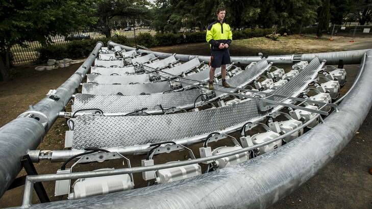 Affinity Electrical apprentice Alex Meek checks over the 94 bulbs in one of the lights at Manuka Oval. Photo: Rohan Thomson