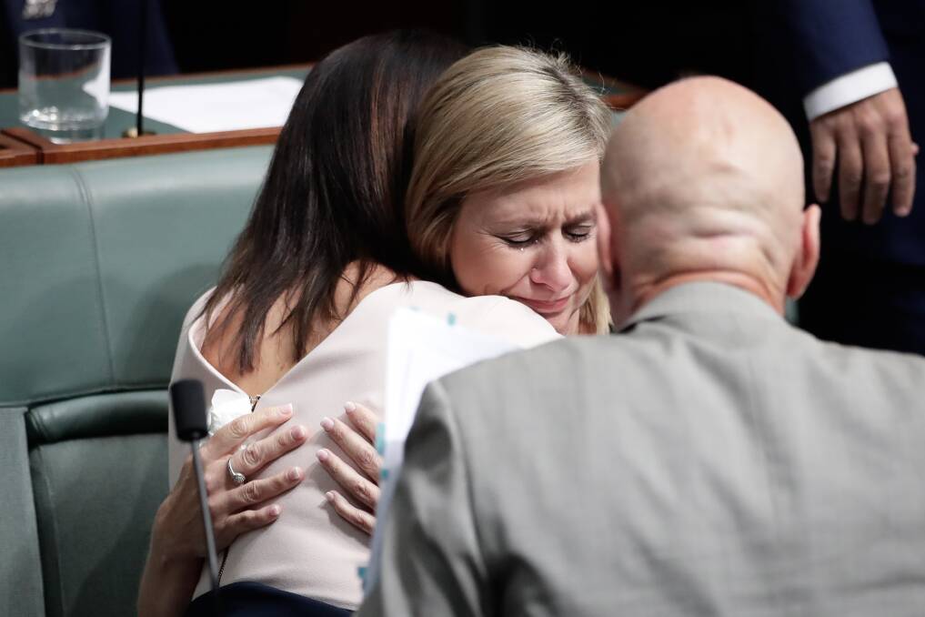 Ms Lamb is comforted by colleague Emma Husar. Photo: Alex Ellinghausen