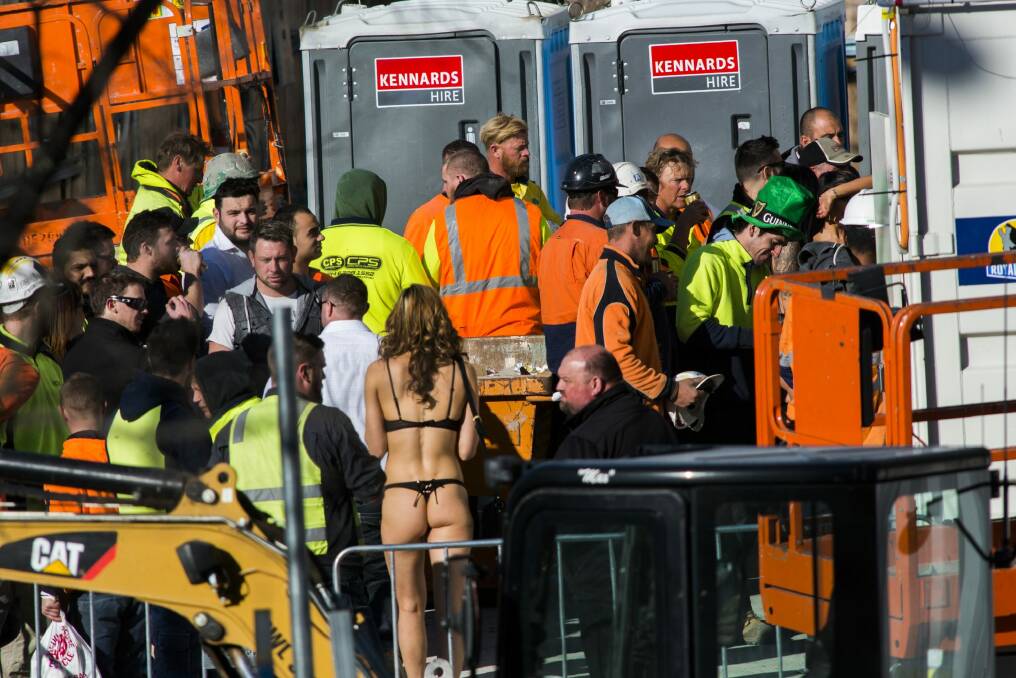 Strippers were seen handing out drinks and mingling with construction workers at the Geocon Wayfarer apartment building site in Belconnen on Friday afternoon. Photo: Rohan Thomson