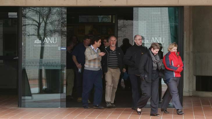 Australian National University staff emerge from a meeting where staffing reforms including early retirements were discussed. Photo: Andrew Meares