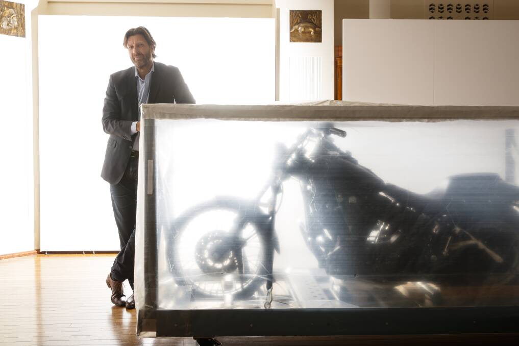 Under wraps: National Film and Sound Archive CEO Jan Müller with Heath Ledger's Harley-Davidson. Photo: Sitthixay Ditthavong