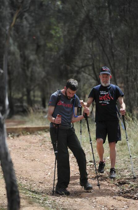 Andrew Short, who has Cerebral Palsy, will embark on his latest physical trek, the Kokoda Track, in April. Joining him is his father David. Here they use Red Hill Nature reserve as their training ground.
 Photo: Graham Tidy
