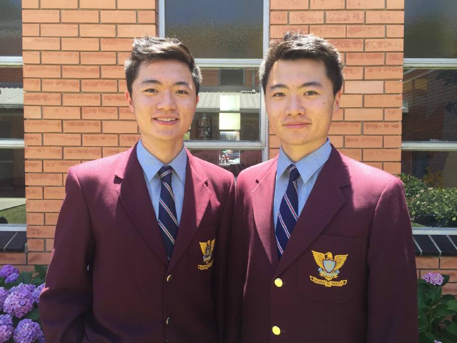 Identical twins Nicholas Cheng (left) and Nathan Cheng (right), who have been named the joint dux at Marcellin College. Photo: Supplied.