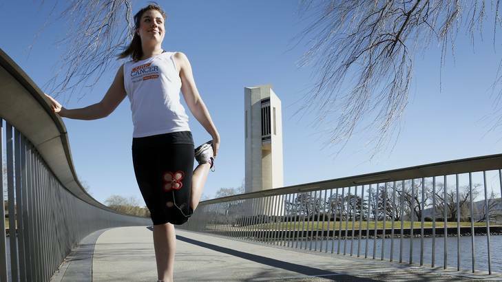 Sarah Arnold, of Braddon, warming up before a run around Lake Burley Griffin in preparation for City2Surf. Photo: Jeffrey Chan