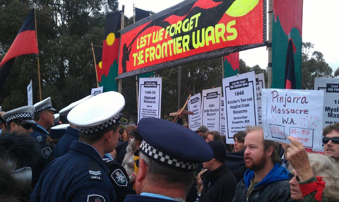 Protesters attempting to crash the 2014 Anzac Day march in Canberra clash with police. Photo: Dylan Wood