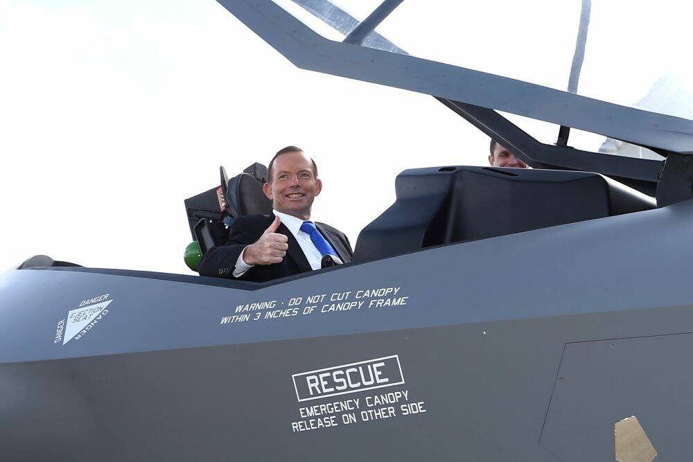 Prime Minister Tony Abbott in a replica of a F-35A Lightning II Joint Strike Fighter. The jobs cull is expected to cut the DSTO's technical team for the plane from six scientists to two. Photo: Alex Ellinghausen