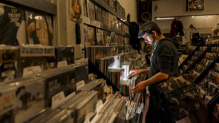 Local part-time DJ Colin McLeod looks through records at Landspeed Records in Garema Place. Photo: Rohan Thomson