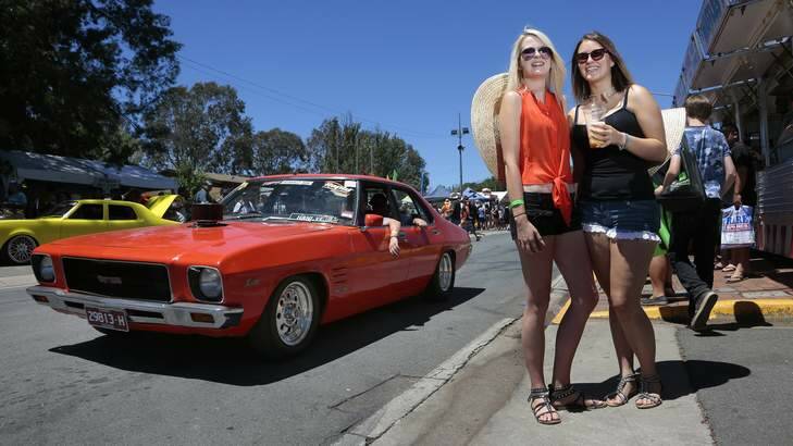 Claire Shipton and Steph Kennedy watching cars cruising around Exhibition Park. Photo: Jeffrey Chan