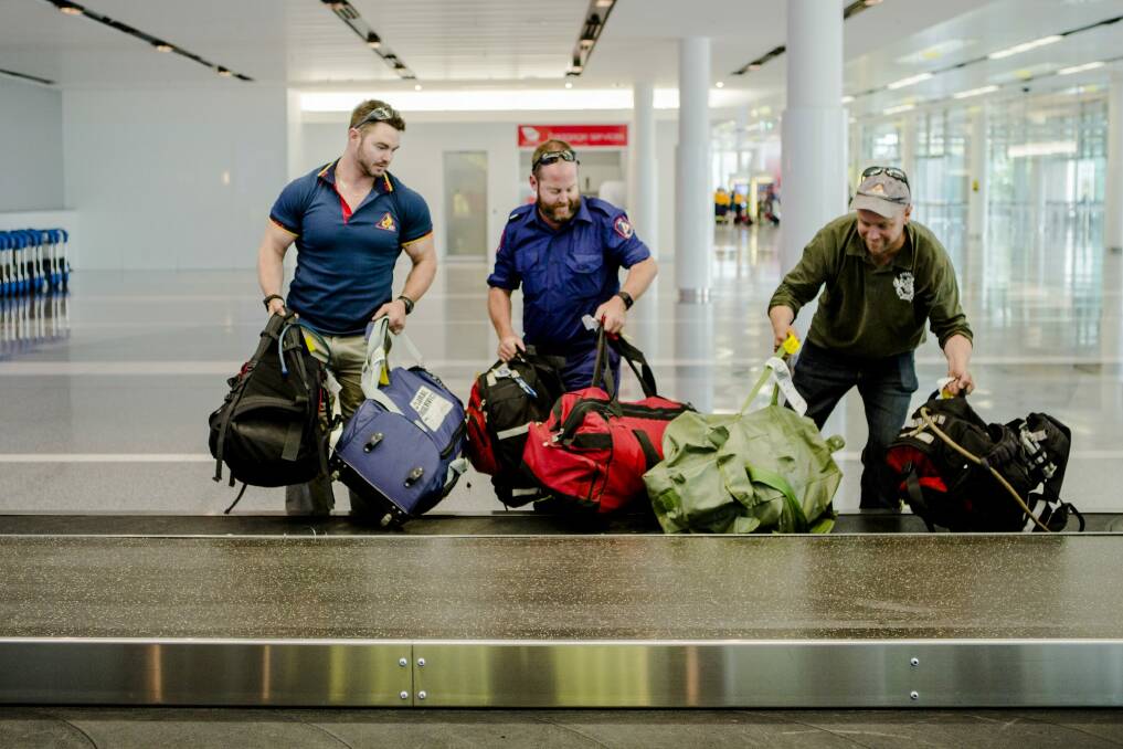 Returning ACT Remote Area Firefighters arrive at Canberra Airport. 
From left, Harley McDonnell, Matt White, and Terry Dwyer. Photo: Jamila Toderas