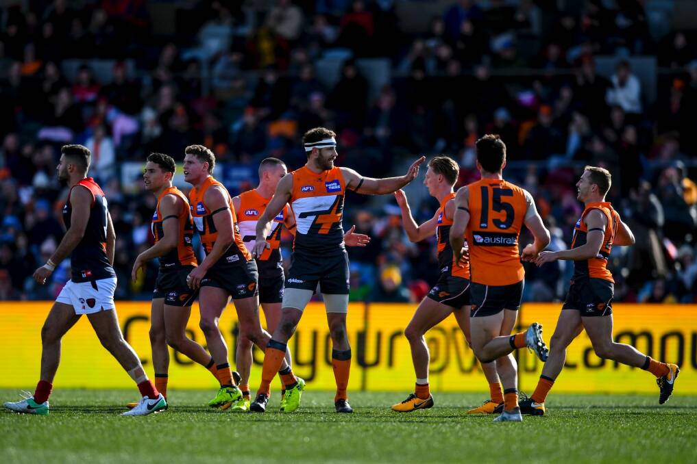 Shane Mumford of the Giants celebrates with team mates. Photo: Lukas Coch
