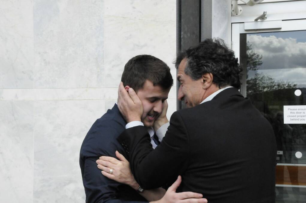 Harlan Agresti is embraced by his father outside court. Photo: Alexandra Back