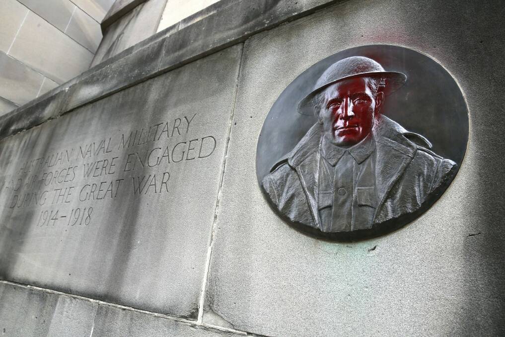 The King George Memorial in front of Old Parliament House has been vandalised with red spray paint. Photo: Jeffrey Chan