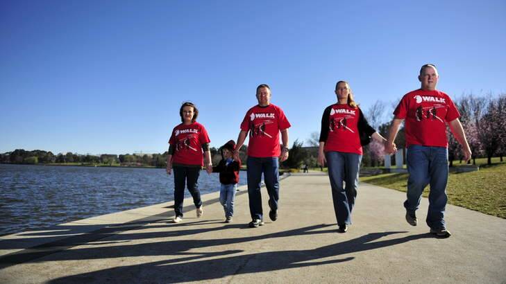 Kim and Gavin Fitt with their son Riley, 4,  and Paula and Andrew Moloney prepare for the big red kidney walk. Photo: Jay Cronan