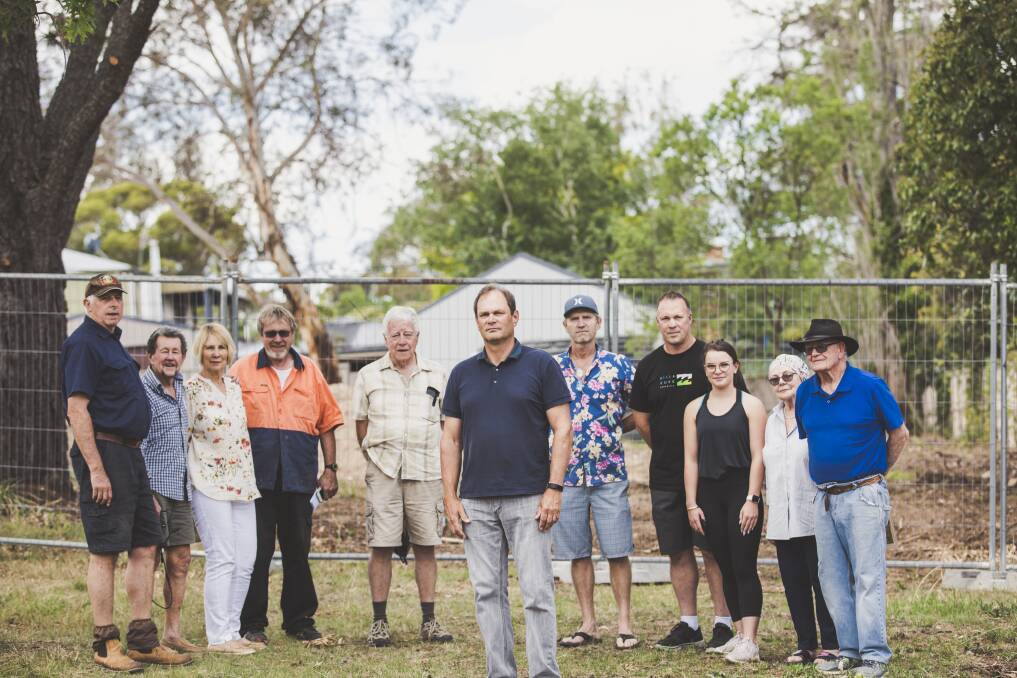 Hall residents are angry about the ACT government's decision not to pursue a prosecution over the unauthorised demolition of a heritage-listed stone cottage. From left, Graeme Bryce, Bob Richardson, Helen White, Danny Clynk, Brian Banyard, Jonathan Palmer, John Sayers, Robert and Jordyn Collins, and Pam and Stan Sparrow. Photo: Jamila Toderas