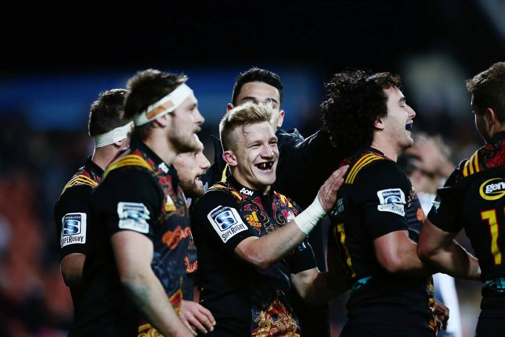 Damian McKenzie, centre, proves you don't have to big to succeed in Super Rugby. Photo: Anthony Au-Yeung