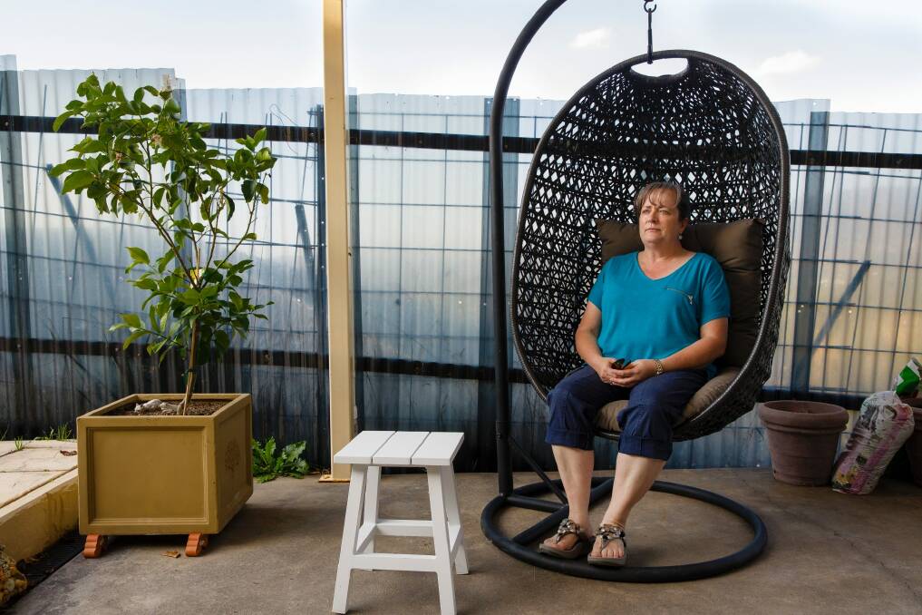 Suzi Maginnity in her backyard in Gordon, which has stunning views of the Brindabellas - interrupted by a "safety fence" due to issues with the site next door. Photo: Sitthixay Ditthavong