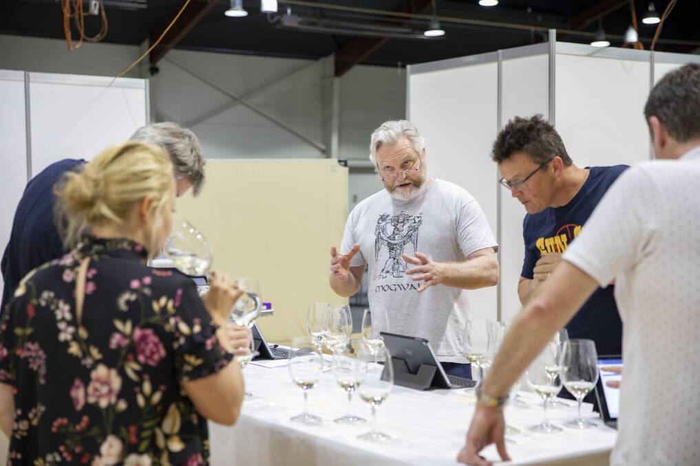 Chair of judges David Bicknell confers with judges at the National Wine Show. Photo: Sitthixay Ditthavong