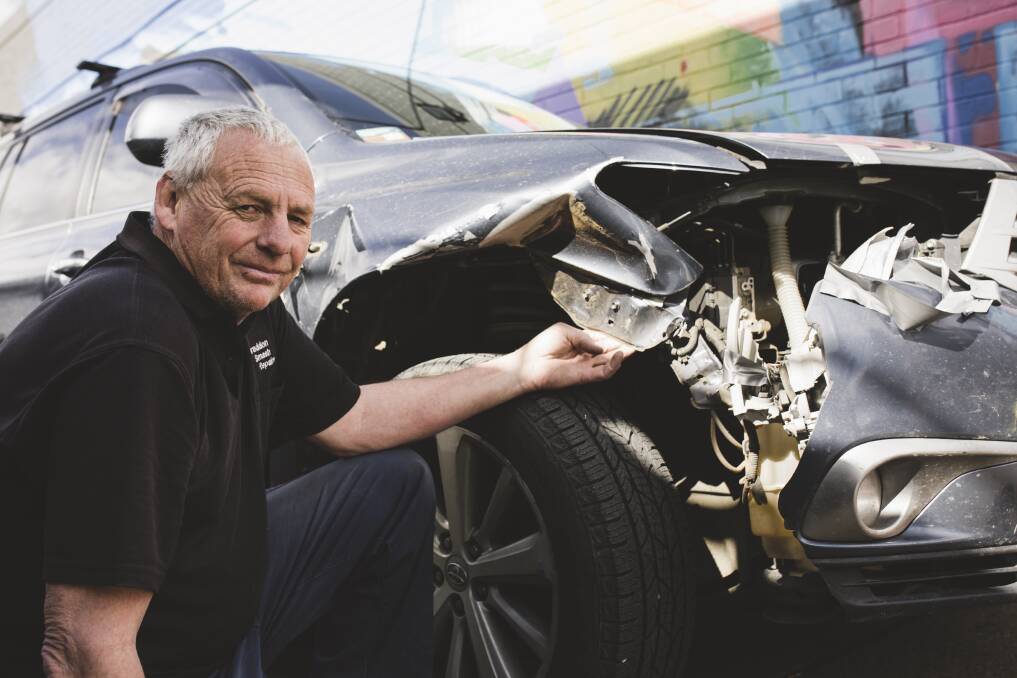 Owner of Braddon Smash Repairs, Jeff Badcoe with a car that has damage from hitting a kangaroo. Photo: Jamila Toderas