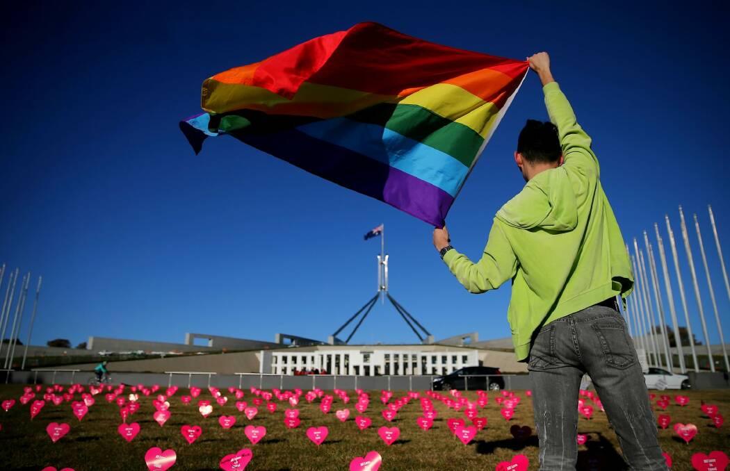 Marriage equality advocate Russell Nankervis with the rainbow flag during a 'Sea of Hearts' event in support of marriage equality at Parliament House earlier this month. Photo: Alex Ellinghausen