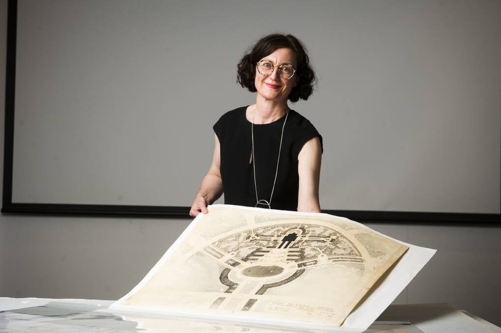Senior curator of offical and private records Margaret Farmer with some of the original designs from the Australian War Memorial before they were scrapped Photo: Dion Georgopoulos