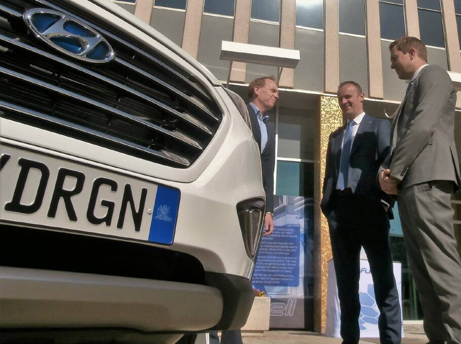 Minister for Environment and Climate Change, Simon Corbell, Chief Minister Andrew Barr, and ACT director of Energy and Waste, Jon Sibley admire the Hyundai ix35 hydrogen car.  Photo: David Ellery