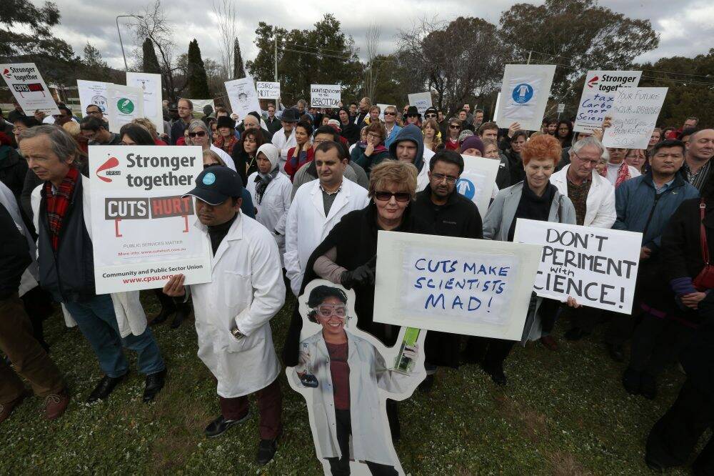 CSIRO employees donned lab coats as they vented their fury about budget cuts in Canberra on Thursday.  Photo: Jeffrey Chan