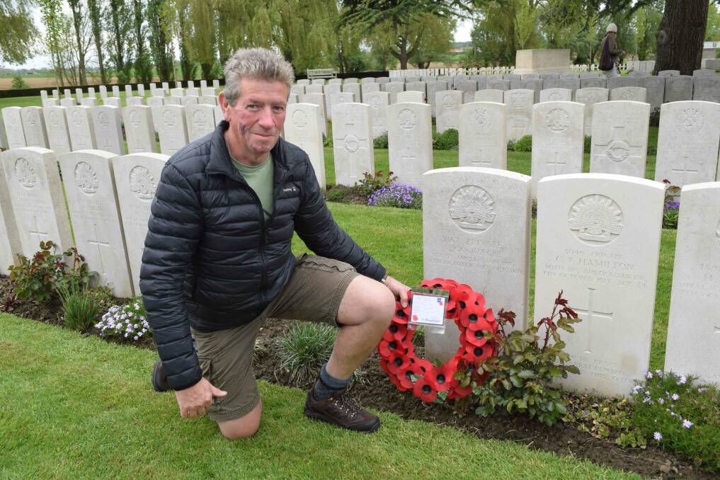 Article author, David Ellery, at the grave of a relative, Albert Goodacre, from Woodstock near Cowra in NSW who was mortally wounded on October 4, 1917.  Photo: David Ellery