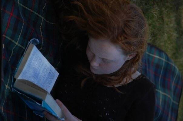 Liv Hewson deep in a book during her childhood in Canberra. Words, stories, language have always been important to her. Photo: supplied