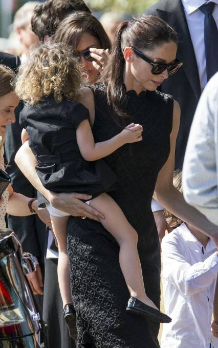 Erica Baxter with her daughter at the funeral of her father, Michael. Photo: Media-Mode