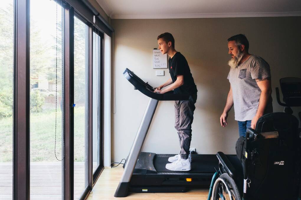 Elijah Arranz on the treadmill with his father Jose, his goals written on the whiteboard behind him. Photo: Rohan Thomson